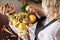 Woman assembles a fruit bouquet of lemons, nuts and mint