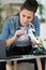 woman assembling drone following instructions on laptop