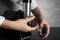 Woman assembling electric meat grinder at black table, closeup