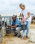 Woman with assistant feeding calves