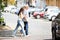 Woman Assisting Her Father While Crossing Road