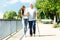 Woman Assisting Her Father While Walking In Park