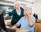 Woman Assisting Male Classmate In Computer Class