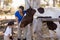 Woman assisting sister for cleaning horse