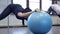 Woman athlete doing exercises on gym ball in fitness studio