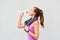 Woman, athlete and drinking water in studio, relax and hydration after workout on white background. Female person