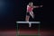 Woman athlete jumping over a hurdles