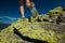 Woman athlete is jumping over stones in mountains