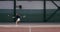 A woman athlete plays tennis, deftly repulsing blow after blow with a racket