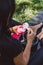 Woman athlete prepares a protein shake in a shaker after training outdoors. Sports nutrition. Soft selective focus