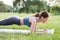 Woman athlete stands in the plank. Woman doing sports exercise in the park