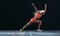 Woman athlete taking off from starting block on a running track