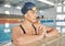 Woman, athlete and thinking by swimming pool for exercise, training or fitness competition. Serious, vision or praying