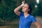 Woman athlete wiping sweat from her forehead