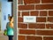 Woman in athletic clothes with in direction of exit sign on brick wall