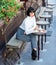 Woman attractive brunette eat gourmet cake cafe terrace background. Gastronomical enjoyment. Girl relax cafe with cake