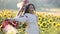 A woman in authentic ukrainian clothes dancing outdoors in green summer fields.