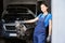 Woman auto mechanic at workplace in workshop