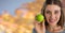 Woman in Autumn with apple in front of orange leaves