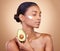 Woman, avocado and cream for skincare, natural beauty and vitamin c benefits on studio, brown background. Young calm