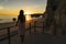 Woman at back enjoying the sunset in the beach in Algarve, Portugal