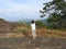 Woman, back view looking at wild monkey in nature, Dambulla, Sri Lanka