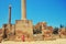 Woman on the background of ancient Roman columns, the ruins of Anthony terms. Archaeological excavations of antique Thermae in