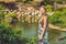 Woman on a background of flamingos on a pond