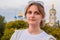 Woman on the background of the Orthodox Church. The dome of the Christian Church in Moscow and a female portrait. A young woman on