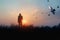 Woman with backpack enjoying sunset on grass peak hill. Bird in the sky. Tourist traveler on sunset background valley landscape. S