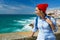 Woman with a backpack enjoys a view of the ocean coast near Azenhas do Mar, Portugal