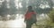 Woman with backpack, fog and lake, hiking on morning winter adventure with peace and walking in calm nature. Relax