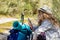 Woman with backpack looking at travel mobile