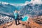 Woman with backpack on the mountain peak in autumn