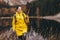 Woman with backpack and raincoat hiking