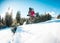 Woman with backpack and snowshoes in the winter mountains