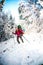 Woman with backpack and snowshoes in the winter mountains