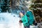 Woman with backpack and snowshoes in the winter mountains