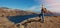 Woman with backpack standing on cliff and looking to the ocean. mountain trekking and hiking. banner with copy space