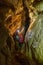 Woman with backpack taking photos in a cave