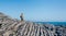 Woman with backpack walking through flysch rock landscape