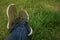 Woman Backpacker Blue jeans Legs Enjoy the View on Green Grass Summer Field