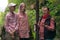 Woman backpacker communicates with two teenage girls among the rocks in a natural landscape