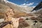 Woman backpacker in cozy clothes trekking in mountains