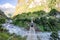 Woman backpacker crossing suspension bridge in Himalayas Nepal