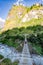 Woman backpacker crossing suspension bridge in Himalayas Nepal