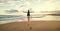 Woman backpacker greeting a sunset at the ocean coast