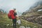 Woman backpacker hiking in foggy mountains