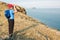 Woman backpacker looks at big lake with binoculars