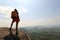 Woman backpacker on mountain peak